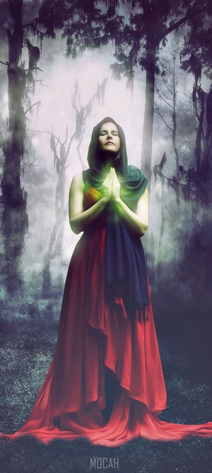 Fantasy girl praying in a misty forest