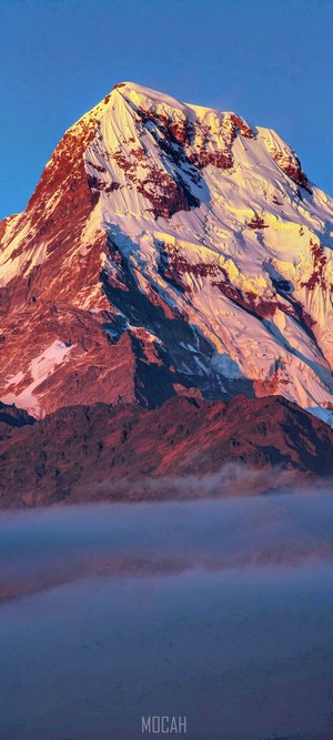 Annapurna mountain peak at sunrise with clouds