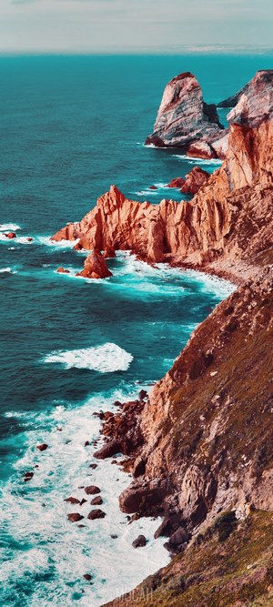 Rugged coastal cliffs meeting turquoise ocean waves