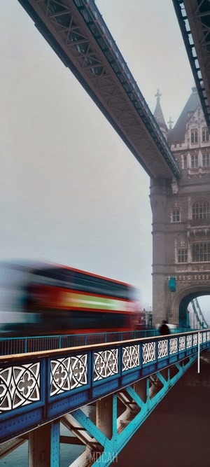 Tower Bridge with a red double-decker bus in motion