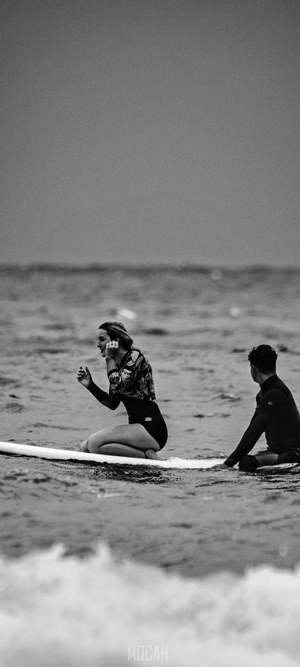 Surfers on surfboards in the ocean