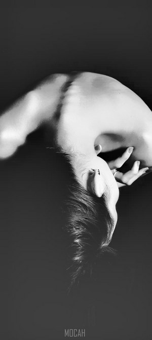 Nude woman arching her back