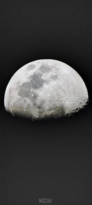 The Moon, partially illuminated against a dark background