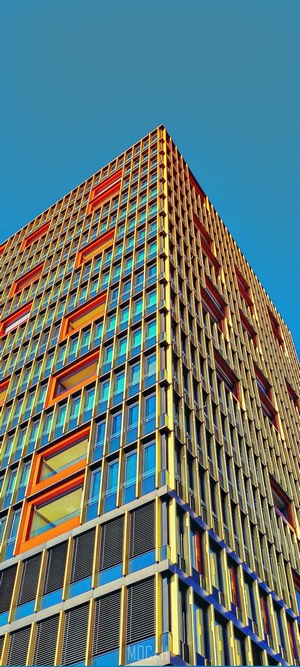 Colorful modern building facade with orange and blue windows