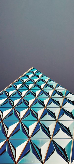 Geometric blue architecture against a dark sky