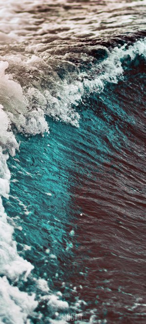 Close-up of a breaking ocean wave with foam