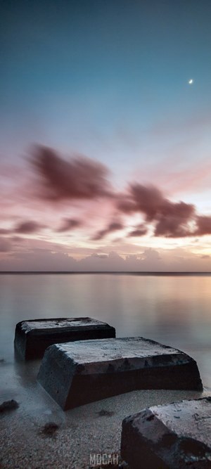 Concrete blocks on a beach at sunset