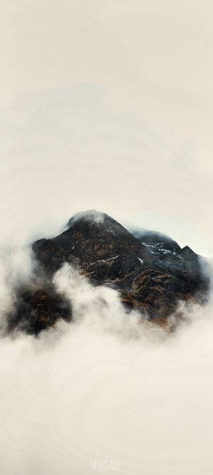 Mountain peak emerging from fog