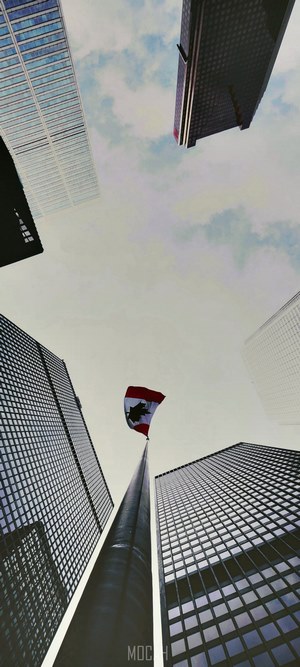 Canadian Flag Flying Between Skyscrapers