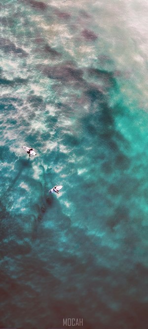 Two surfers on surfboards in the ocean