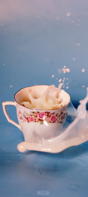 Milk splash in a floral teacup