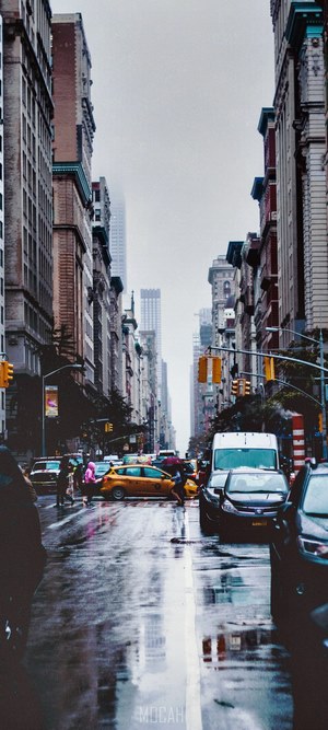 Rainy street in New York City with yellow taxi
