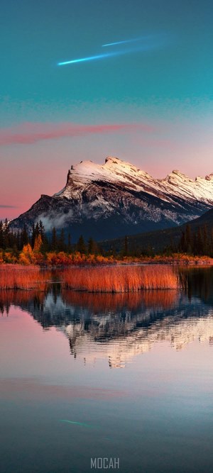 Mountain lake with reflection and shooting star