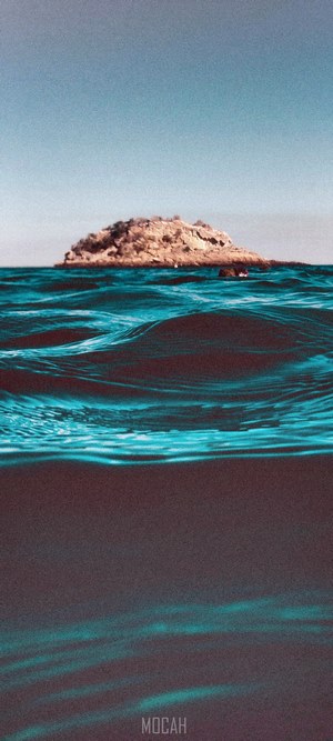 Island in the ocean with waves
