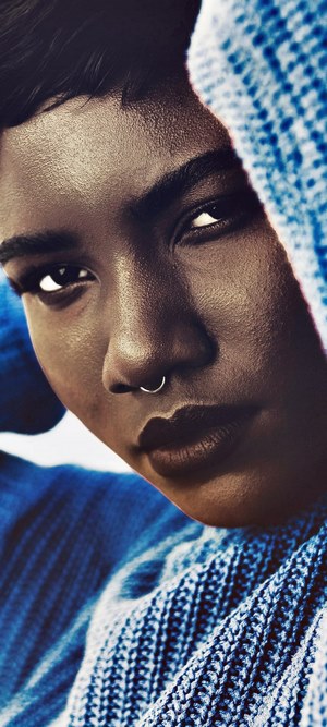 Woman with nose ring wearing blue sweater