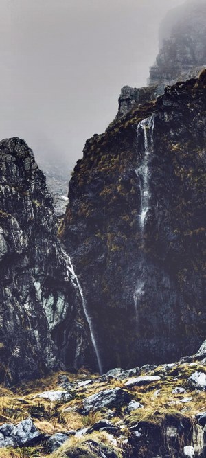 Waterfall on a misty mountainside in Mount Aspiring National Park