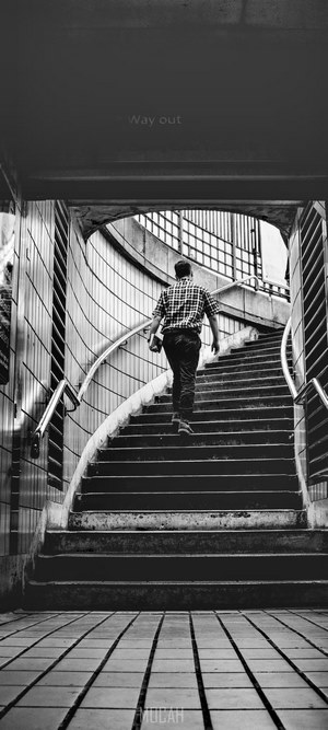 Man walking up stairs in subway
