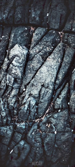 Dark rock texture with water and sand