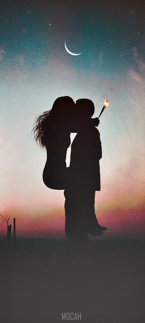 Couple kissing with sparkler under crescent moon