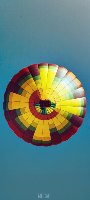 Hot air balloon seen from below against a blue sky