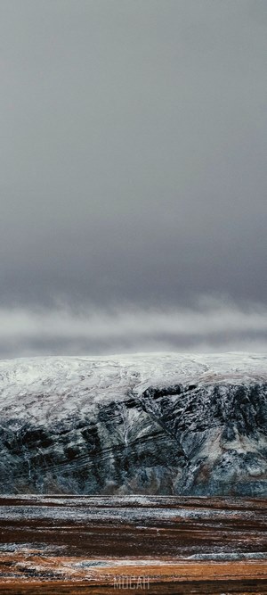 Snowy mountain landscape with overcast sky