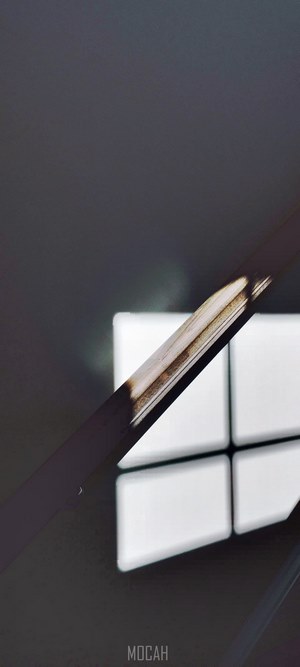 Shadows on a wooden bannister with window light