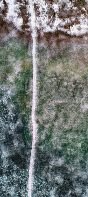Drone shot of a frozen road in a wasteland