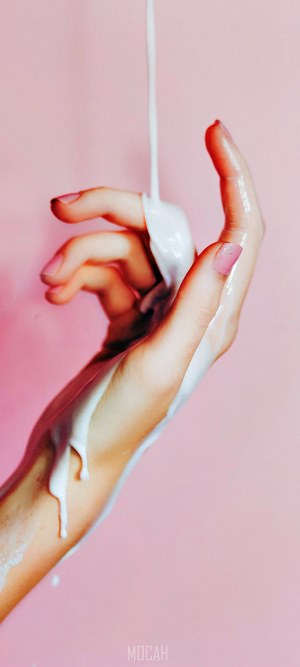 White liquid pouring on a hand