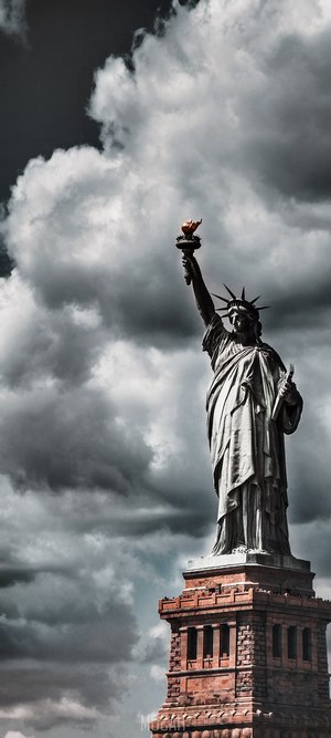 Statue of Liberty against stormy clouds