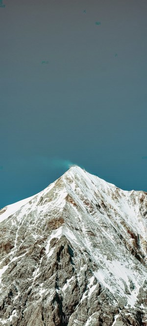 Snowy mountain peak with blue sky