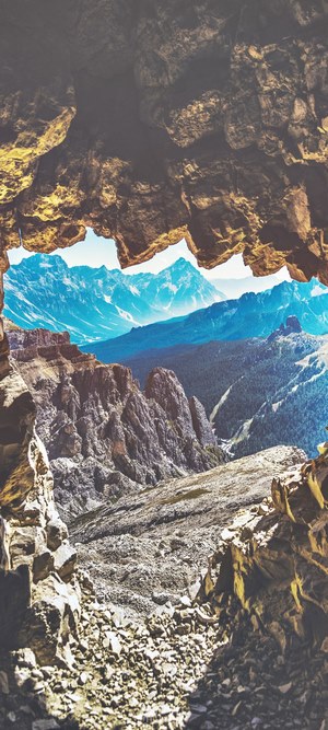 View of mountains through a cave opening