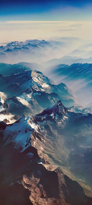 Aerial view of snow-capped mountains during flight