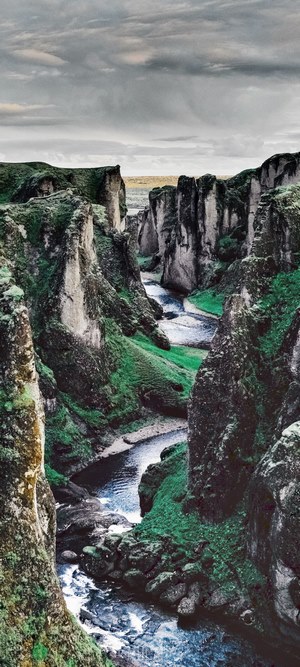 Fjadrargljufur canyon with river and green mossy cliffs
