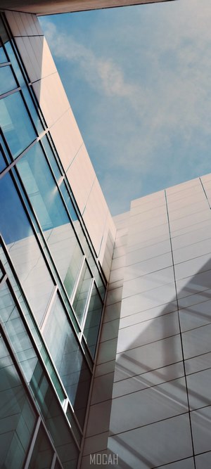 Modern building with glass windows against blue sky