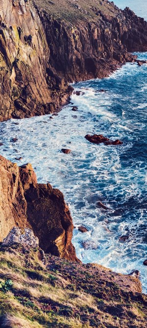 Waves crashing on rocky cliffs at Land's End