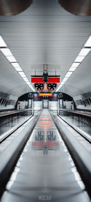 Symmetrical Subway Station with Escalators and Red Signs