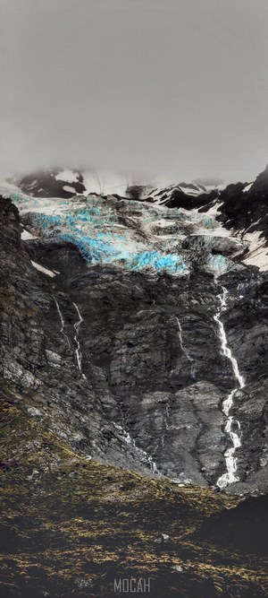 Glacier on a rocky mountain with waterfalls