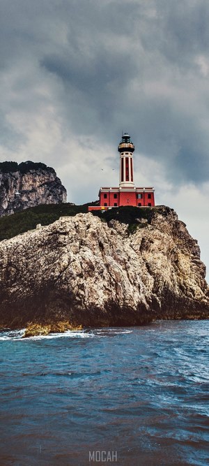 Lighthouse on a rocky cliff overlooking the sea