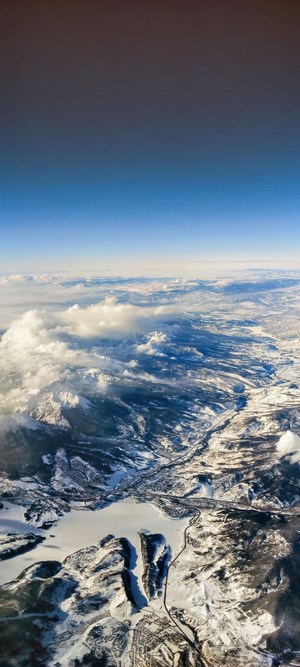 Aerial view of snow-covered mountains and clouds