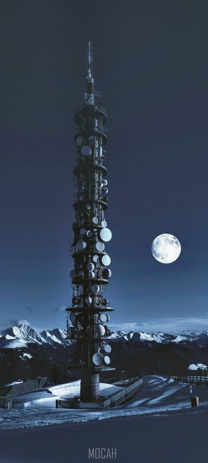 Tower with Moon over Snowy Mountains at Night
