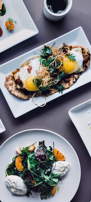 Fried eggs on flatbread with salad and coffee
