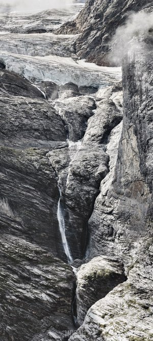 Waterfall cascading down a rocky cliff face