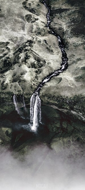 Aerial view of a waterfall flowing into a dark pool