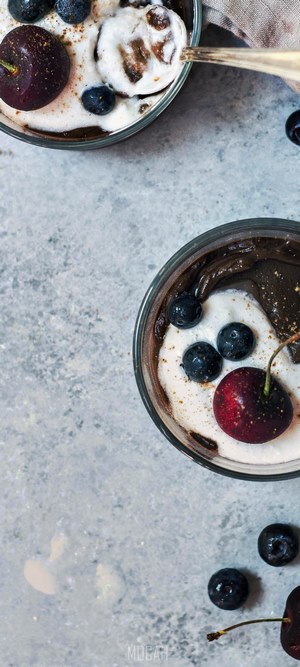 Chocolate avocado pudding with cherries and blueberries