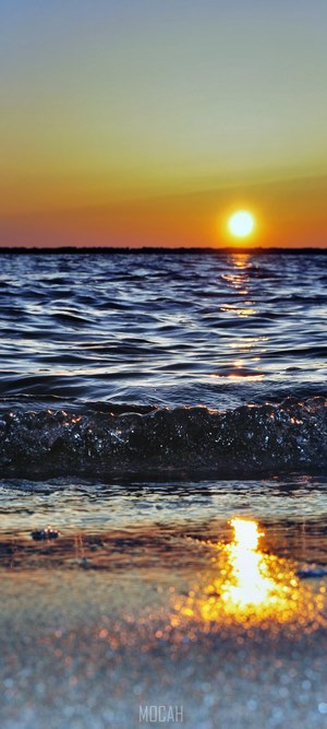 Sunset over the ocean with waves