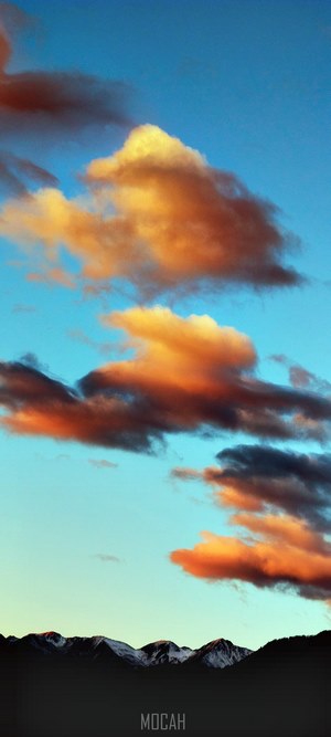 Sunset clouds over snow-capped mountains