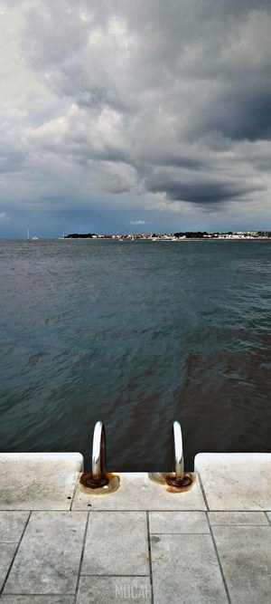 Sea ladder on a pier overlooking the sea