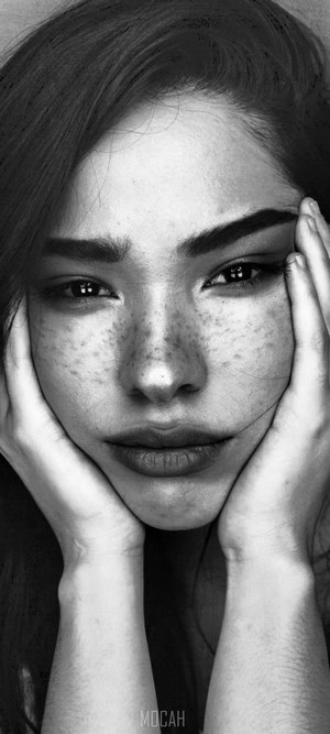 Black and white portrait of a young woman with freckles