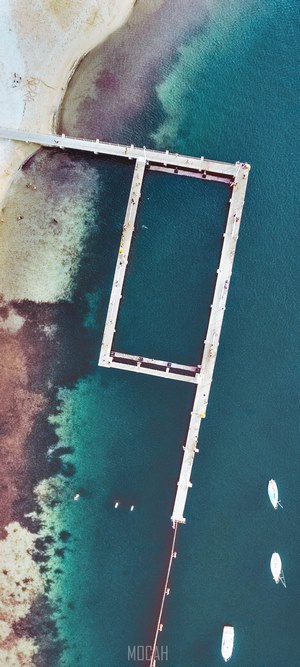 Aerial view of a pier and ocean