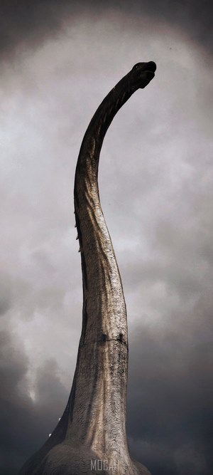 A dinosaur statue against a cloudy sky